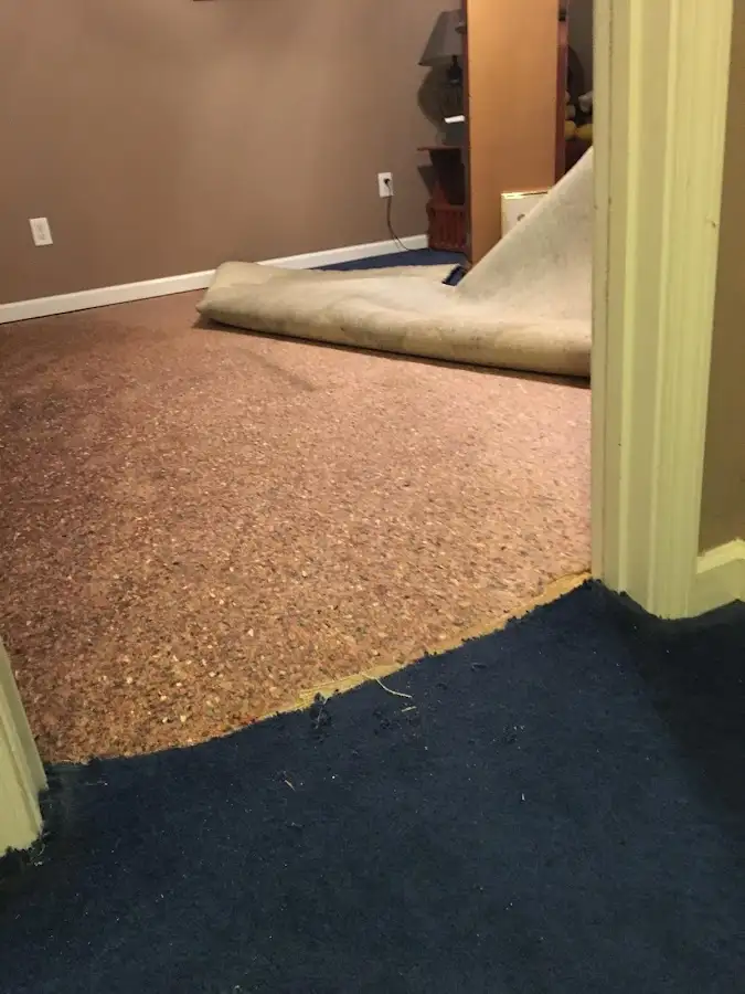Carpet pad removal revealing water damage during Drying & Dehumidification in Hutchinson