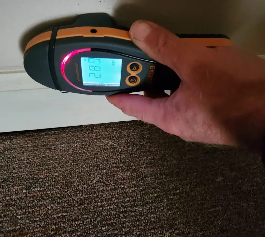 Moisture detection at baseboard during Storm Damage Restoration in Hutchinson